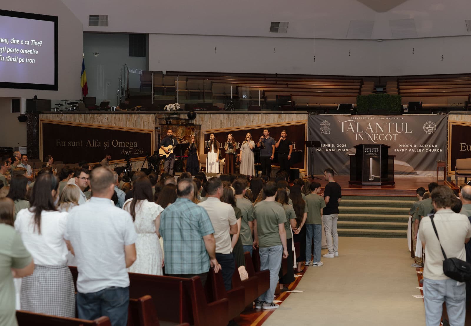 Congregation standing as the worship team leads