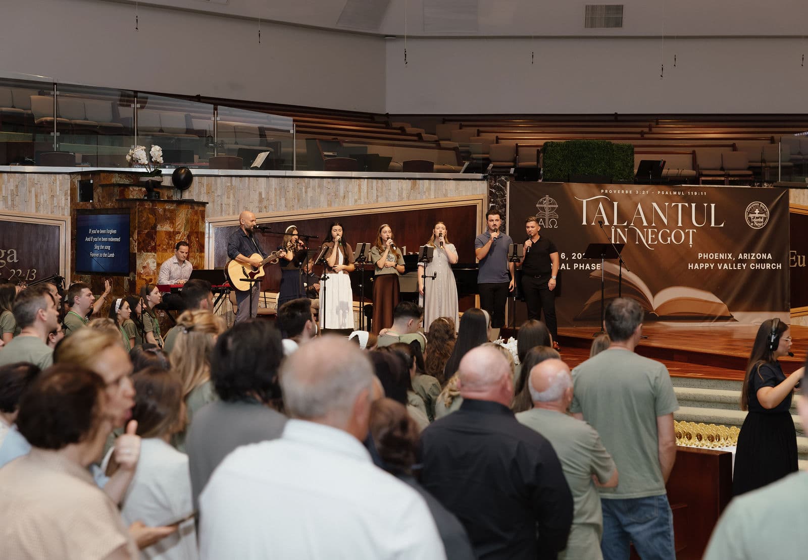 Worship team in front of the national banner